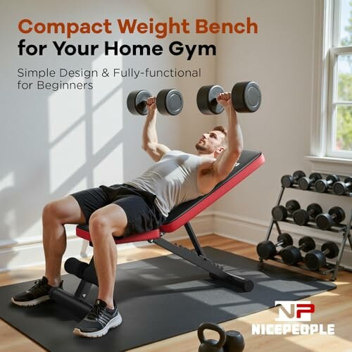 Man using a compact weight bench with dumbbells in a home gym.