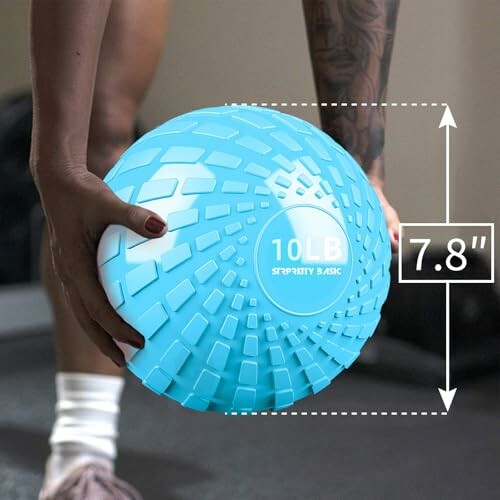 Person holding a textured blue 10 lb medicine ball