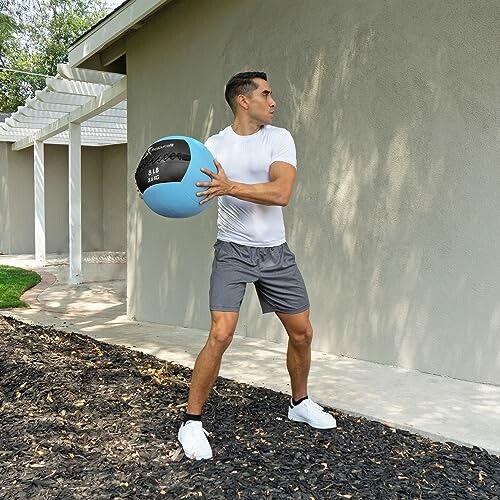 Man exercising outdoors with a medicine ball