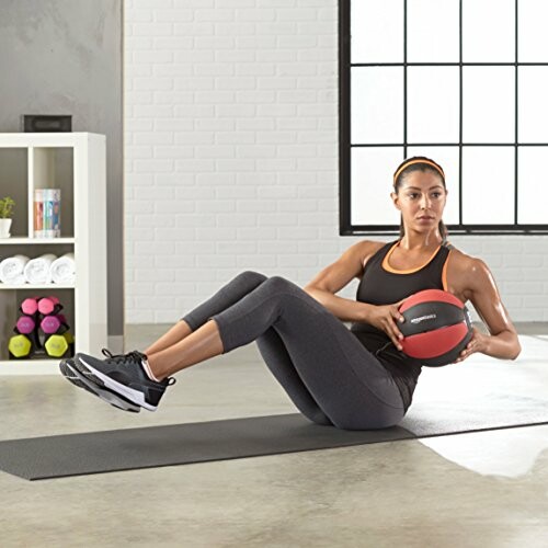 Woman exercising with a medicine ball indoors